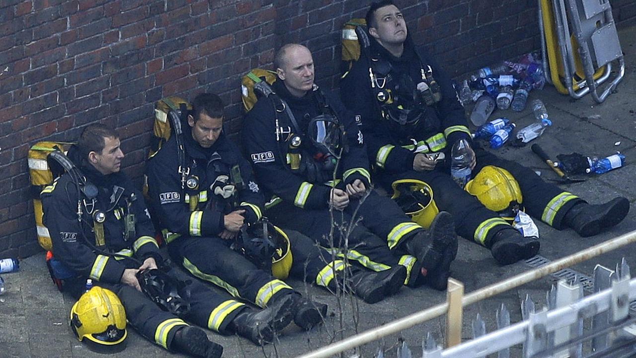 Die Feuerwehr sucht nach Überlebenden in Londoner Hochhaus. Das Bild zeigt erschöpfte Feuerwehrleute.
