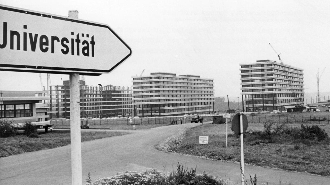 Ein Straßenschild weist auf die Gebäude der am 30.06.1965 eröffneten Ruhr-Universität in Bochum, aufgenommen 1965. 