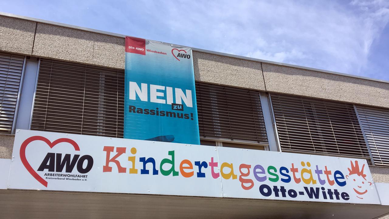 Ein großes blaues Transparent mit der Aufschrift "Nein zu Rassismus" hängt an der Fassade einer Kindertagesstätte der Arbeiterwohlfahrt Hessen.