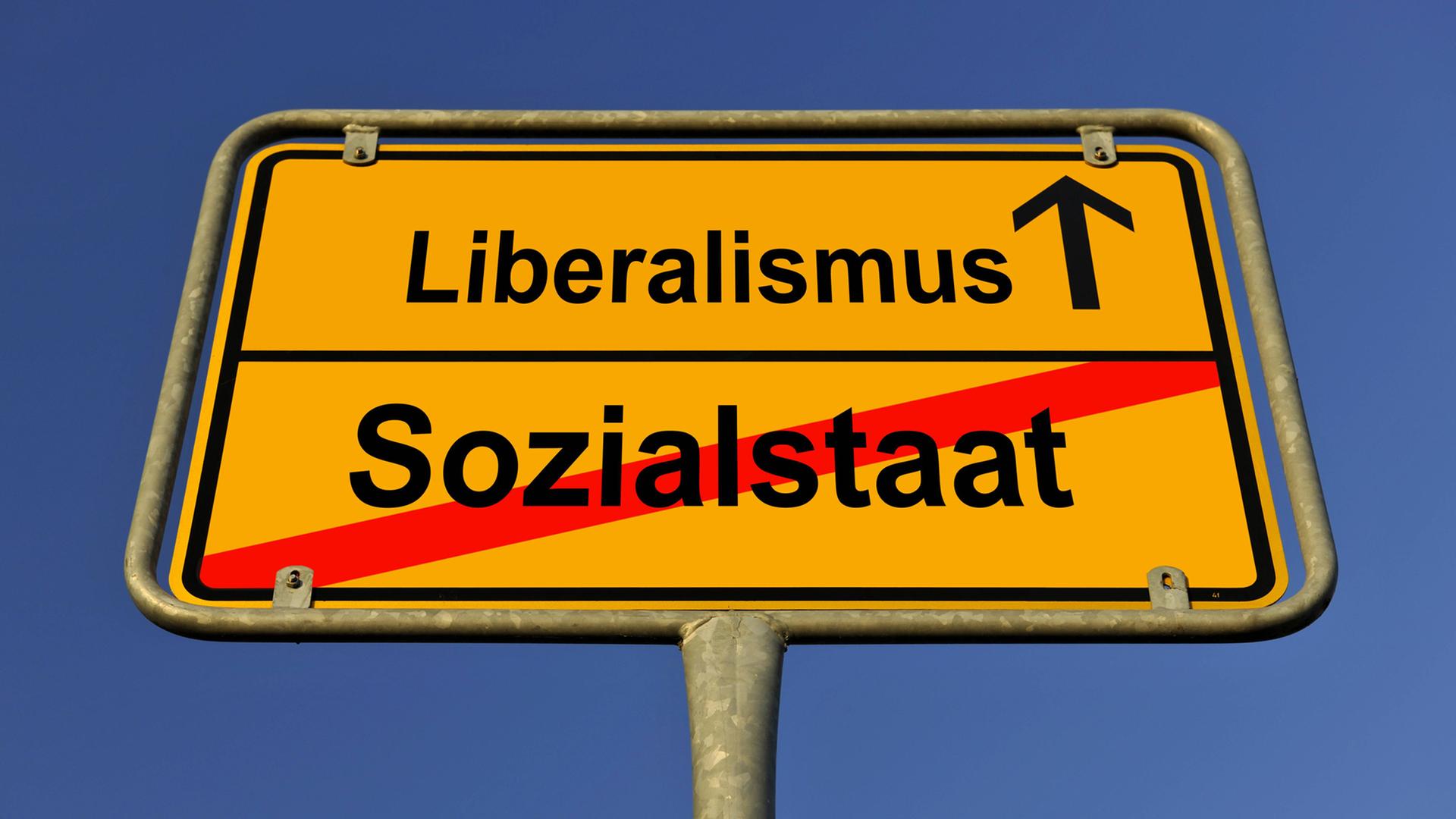 Schild Ortsende: Liberalismus folgt, Sozialstaat durchgestrichen