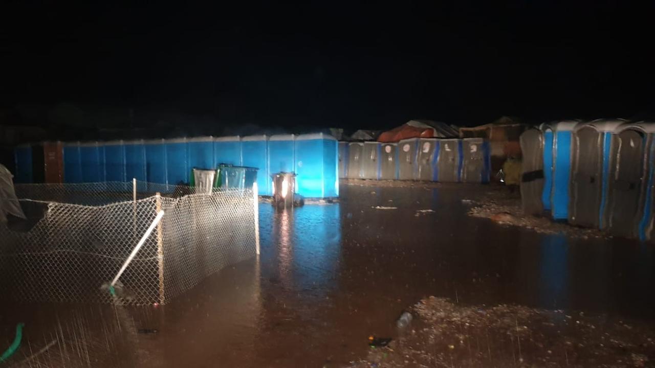 Ein Lager und die blauen Toilettenhäuschen des Lagers sind komplett unter Wasser.