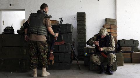 Ukrainische Soldaten reinigen ihre Gewehre.