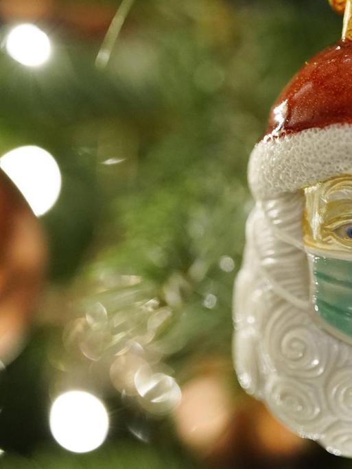 Weihnachtsmann am Baum mit Maske (Symbolfoto)