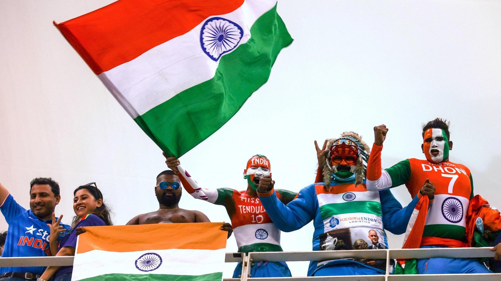 24th October 2021 Dubai International Cricket Stadium Supporters of India wearing costumes yell and wave a national flag during the ICC Men s T20 World Cup match between India and Pakistan at Dubai International Cricket Stadium PUBLICATIONxNOTxINxUK ActionPlus12334161 DavidxGray