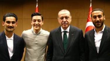 Das Bild zeigt unter anderem die deutschen Fußball-Nationalspieler Özil und Gündogan sowie den türkischen Staatspräsidenten Erdogan. 