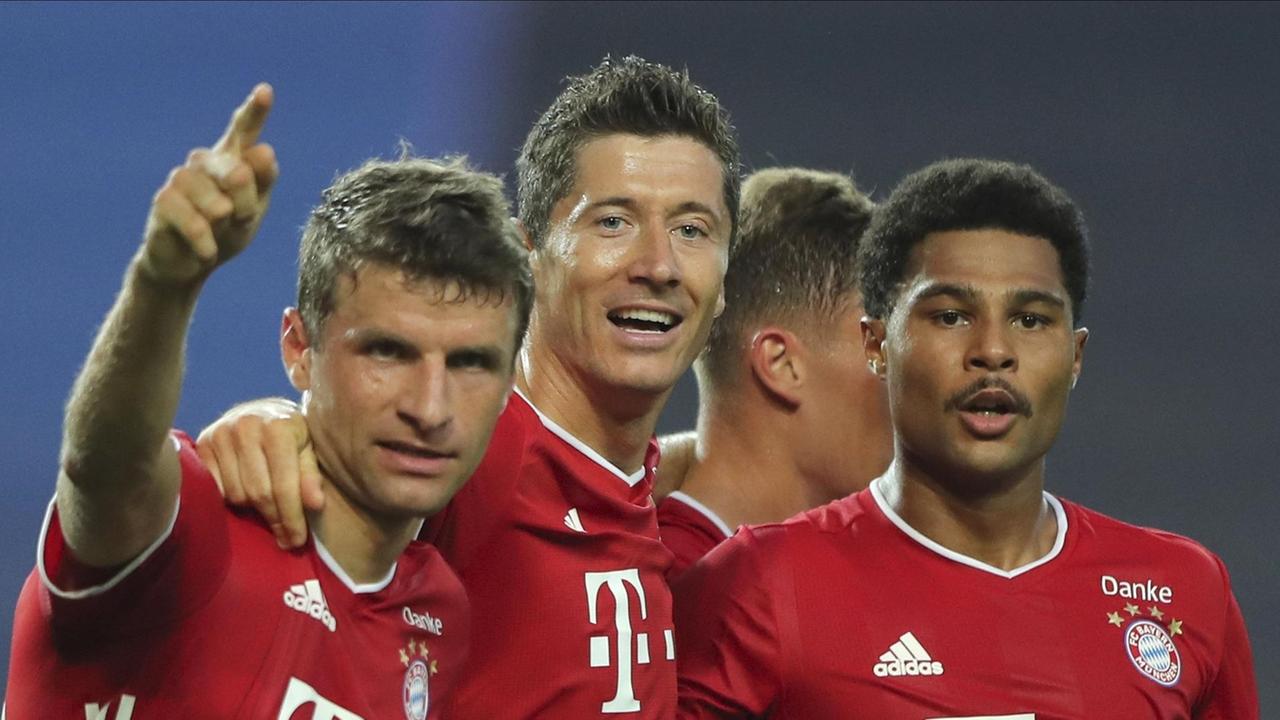 Die Bayern-Spieler Müller, Lewandowski und Gnabry jubeln. 