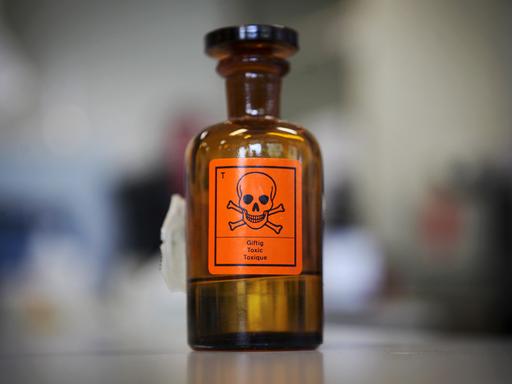 Eine Chemieglasflasche mit einem Aufkleber für "giftig" und einem Totenkopf-Symbol