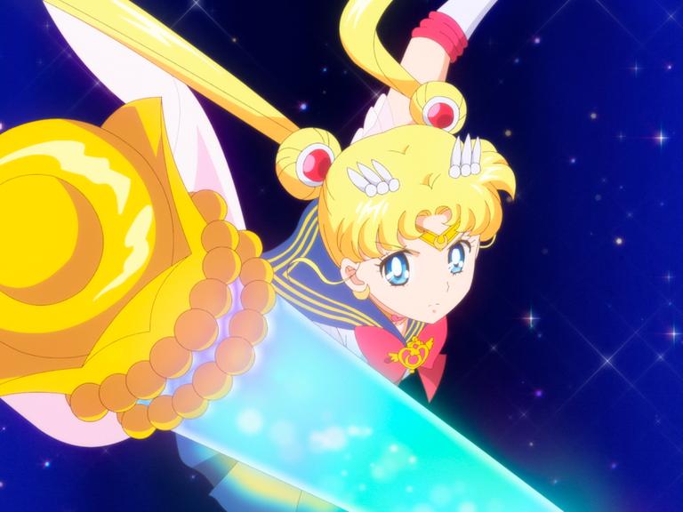 Eine Animefigur: ein Mädchen mit zwei blonden Zöpfen hält ein Zepter in der Hand. Es handelt sich um Sailor Moon.