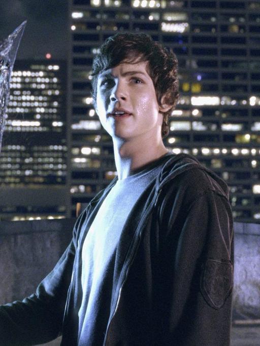 "Percy Jackson"-Darsteller Logan Lerman hält triumphierend den Dreizack seines Vaters in der Hand, des griechischen Gotts Poseidon. Szene aus dem Film "Percy Jackson – Diebe im Olymp", der auf den Romanen von Rick Riordan beruht.