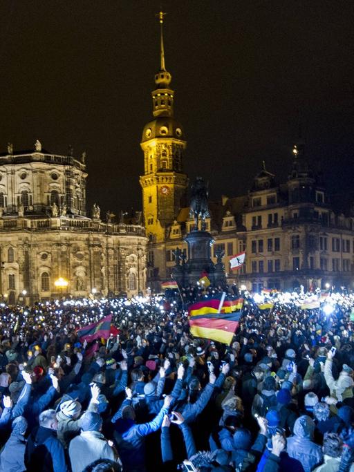 Teilnehmer einer Demonstration des Bündnisses Patriotischer Europäer gegen Islamisierung des Abendlandes (Pegida) sind am Montagabend (22.12.14) auf dem Theaterplatz in Dresden versammelt.