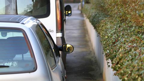 Parkende Autos verengen den Gehweg