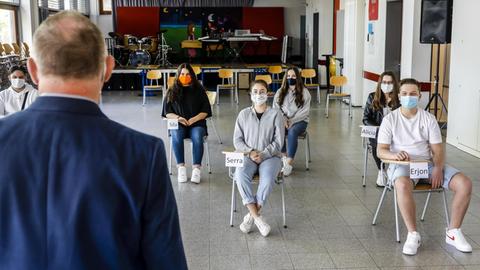 Schüler tragen Masken beim Unterricht im Musikraum