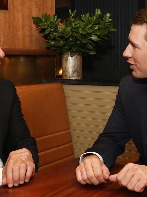 Der österreichischer Bundeskanzler Christian Kern (L) und Außenminister Sebastian Kurz unterhalten sich an einem Tisch während eines Aufenthaltes in New York am 18.09.2016