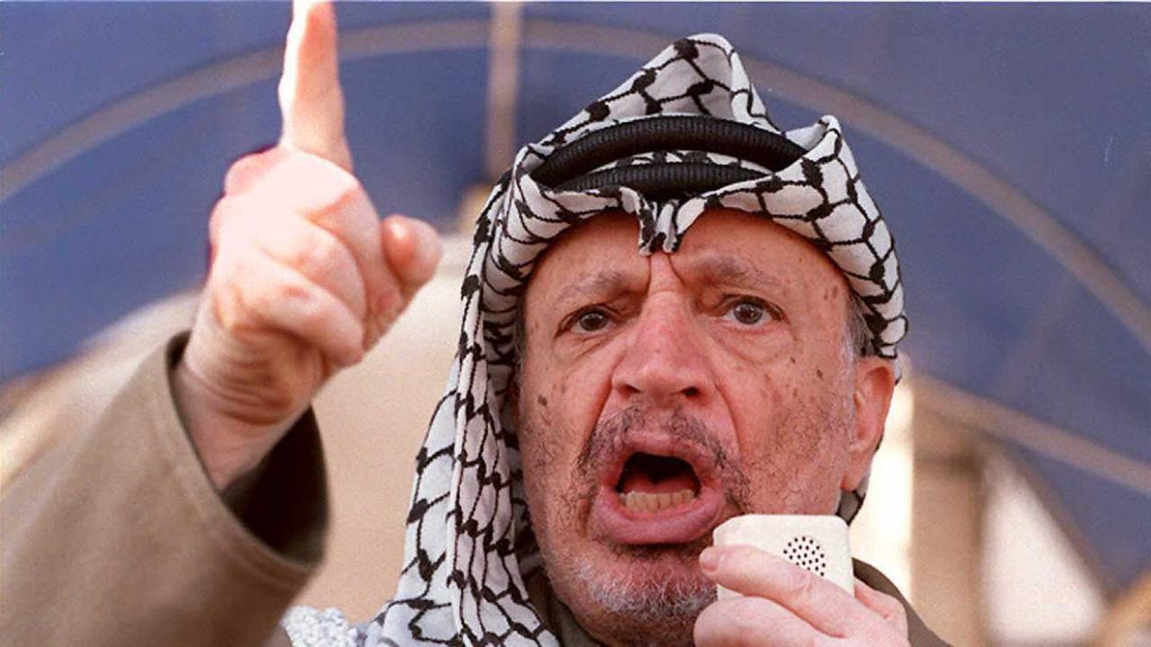 Palestinian President Yasser Arafat speaks in front of the headquarters of the Palestinian Authority in Gaza City 16 March to about 500 people gathered there.  Arafat accused Iran of masterminding the suicide bombings in Israel that recently killed 61 peo