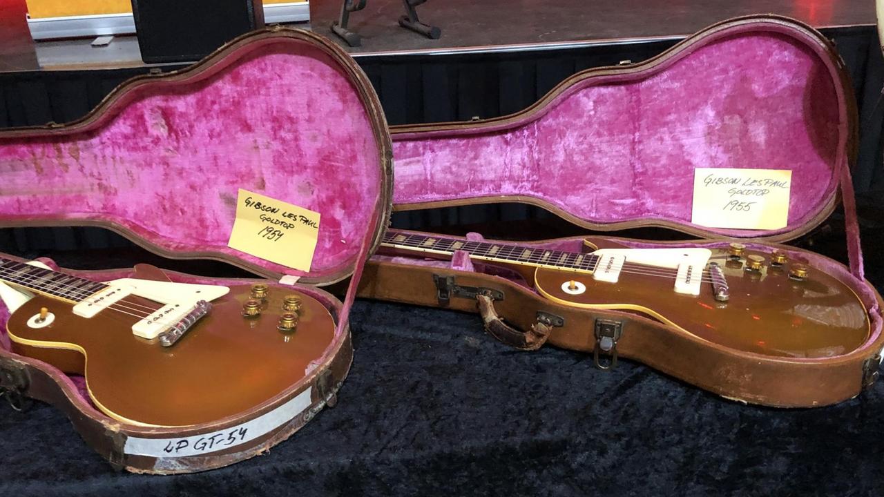Zwei Gibson Les Paul Goldtops liegen in geöffneten Gitarrenkoffern.