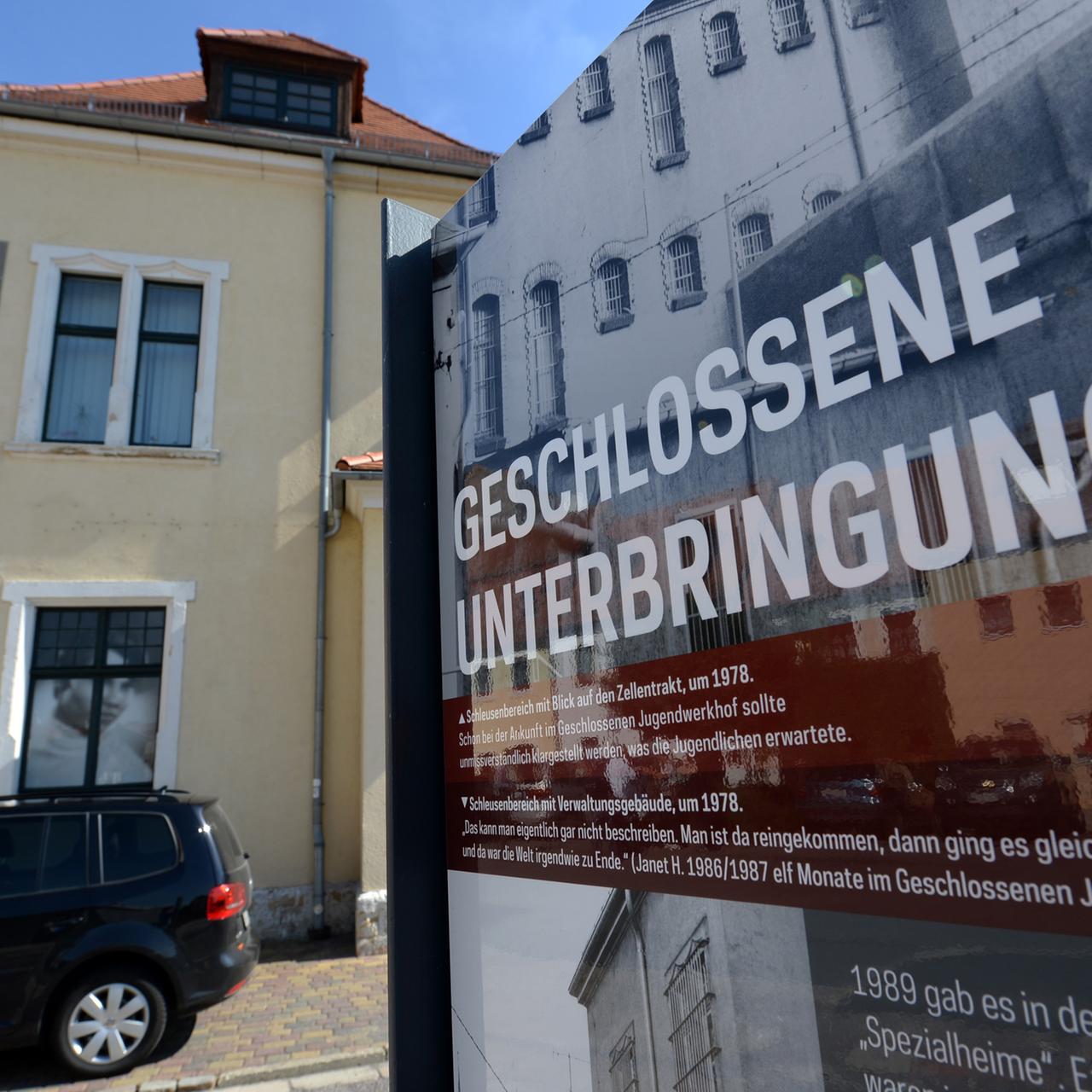 Eine Informationstafel mit der Aufschrift "Geschlossene Unterbringung" steht am 14.09.2013 neben dem Gebäude des ehemaligen Jugendwerkhofes und der heutigen "Gedenkstätte Geschlossener Jugendwerkhof" in Torgau (Sachsen).