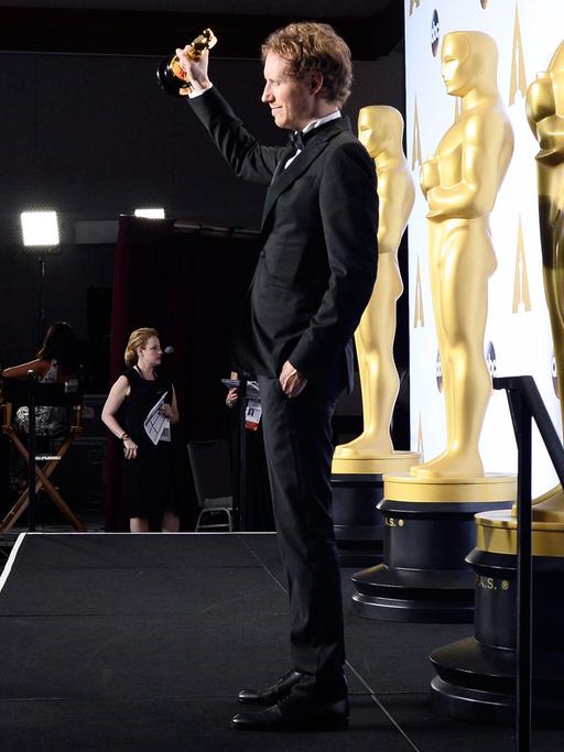 Regisseur Laszlo Nemes hält einen Oscar in der Hand, den er für seinen Film "Son of Saul" erhalten hat.