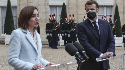 Moldova's President Maia Sandu, left, and France's President Emmanuel Macron meets the media prior to a working lunch at the Elysee Palace in Paris, Thursday, Feb. 4, 2021. Moldova's President Maia Sandu is in Paris for bilateral talks with France's President Emmanuel Macron. (AP Photo/Michel Euler)