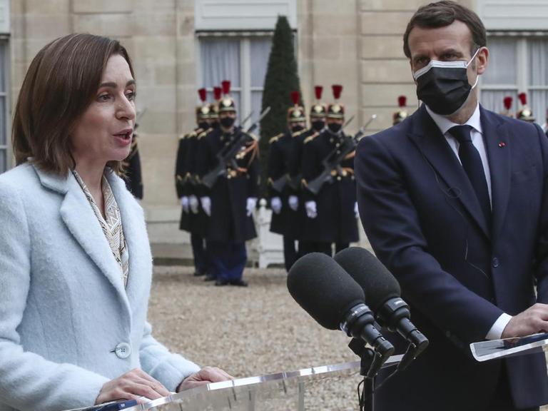 Moldova's President Maia Sandu, left, and France's President Emmanuel Macron meets the media prior to a working lunch at the Elysee Palace in Paris, Thursday, Feb. 4, 2021. Moldova's President Maia Sandu is in Paris for bilateral talks with France's President Emmanuel Macron. (AP Photo/Michel Euler)