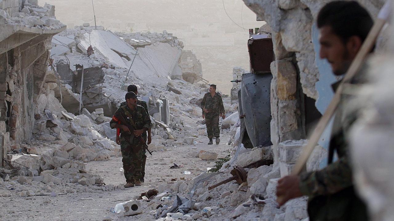 Sie sehen syrische Soldaten in einem Flüchtlingslager in Aleppo.