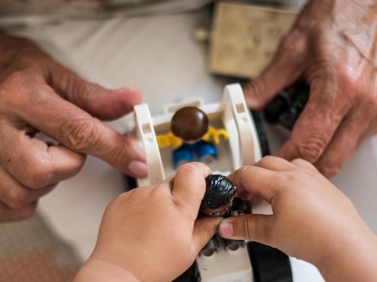 Eine Seniorin spielt mit einem zweijährigen Kind. Im «Mehrgenerationen Haus Bad Nauheim» begegnen sich Menschen unabhängig von Alter und Herkunft. Unter anderem möchte das Zentrum generationenübergreifendes Denken und Handeln fördern.