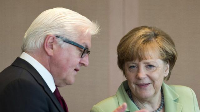 Bundeskanzlerin Angela Merkel (CDU, r.) spricht mit Außenminister Frank-Walter Steinmeier (SPD) bei einer Sitzung des Bundeskabinetts.