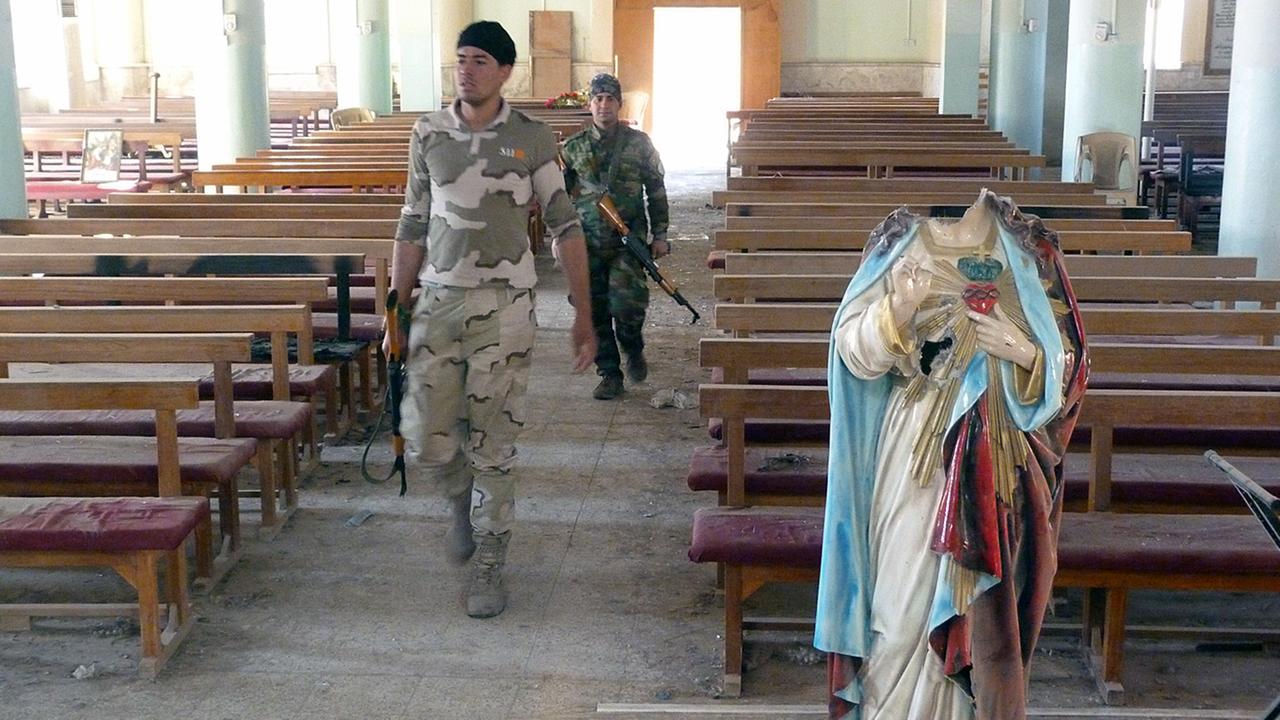 Irakische Regierungssoldaten in der ausgebrannten Sankt Adday Kirche im irakischen Karamlesh, wenige Kilometer östlich von Mossul.