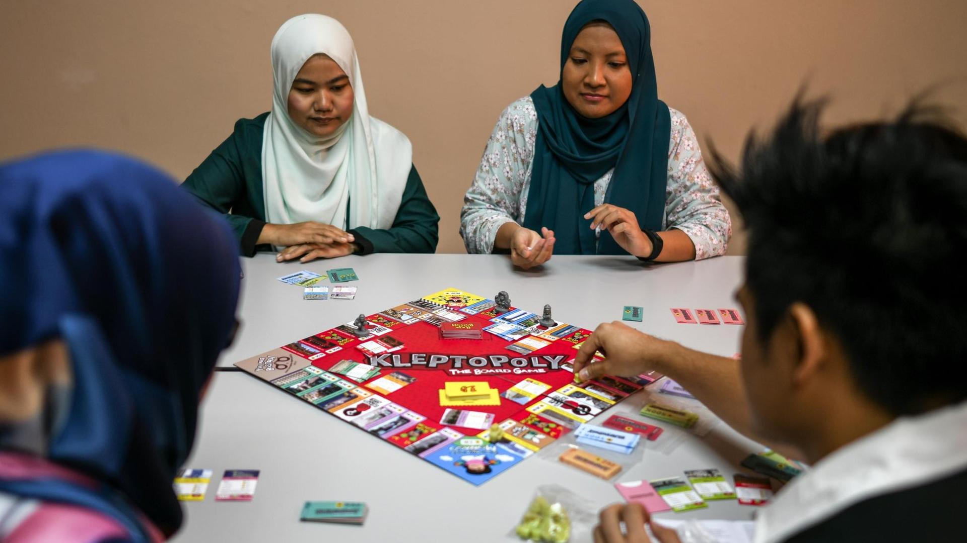 Mitarbeiter des Zentrums für den Kampf gegen Korruption und Vetternwirtschaft in Malaysia spielen "Kleptopoly": Bei dem Brettspiel nach "Monopoly"-Vorbild geht es darum, sich als Politiker möglichst viele Staatsgelder, Grundstücke und Firmen unter den Nagel zu reißen