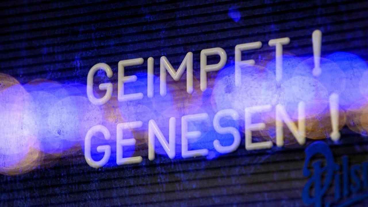 "Geimpft Genesen!" steht in einem Schaukasten an einer Bar in der Dresdner Neustadt.