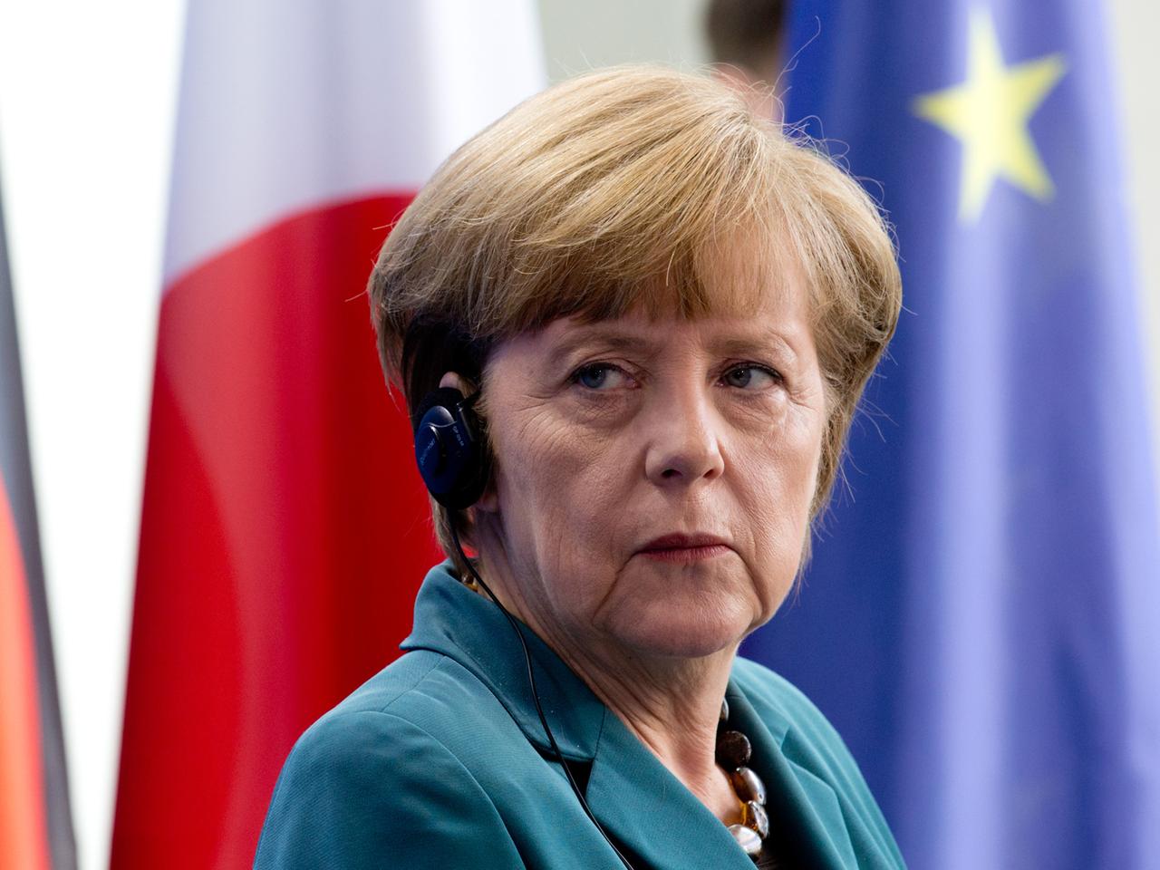 Bundeskanzlerin Angela Merkel vor Fahnen