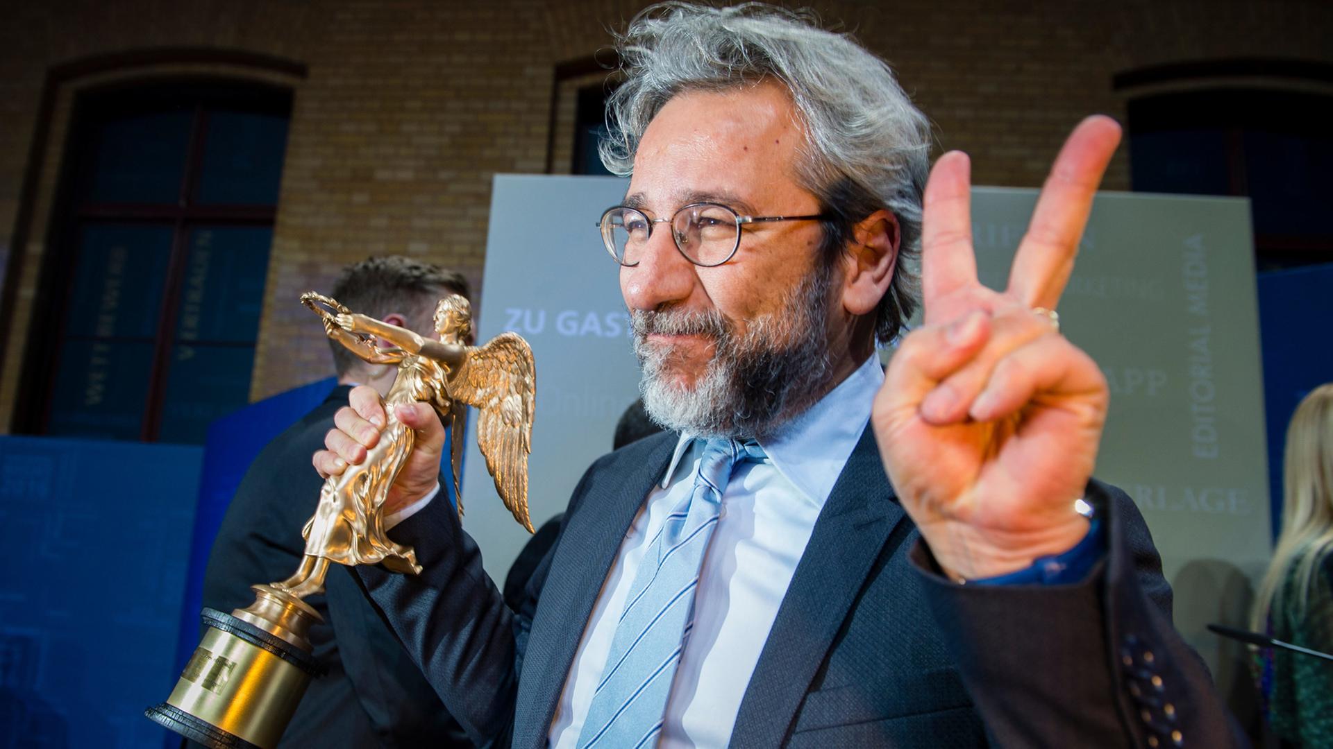 Der ehemalige Chefredakteur der regierungskritischen Zeitung "Cumhuriyet" aus der Türkei, Can Dündar, hält am 7. November 2016 die "Goldene Victoria" in den Händen. Er bekam die Auszeichnung für die "Pressefreiheit" auf der Publishers Night 2016 des Verbandes Deutscher Zeitungsverleger.