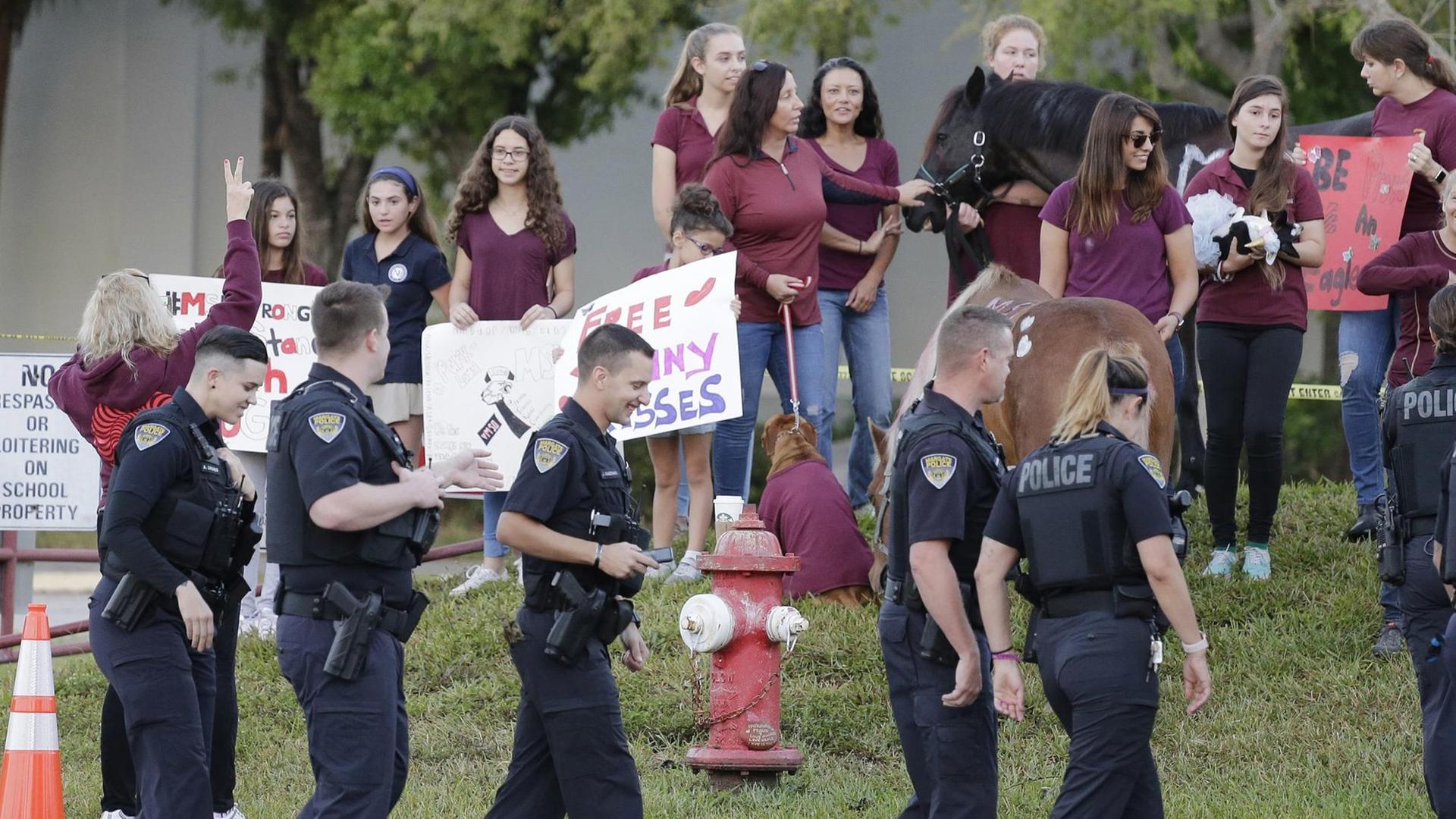 Polizisten begleiten die Schüler der Marjory Stoneman Douglas High School in Parkland in den Unterricht. Polizisten begleiten die Schüler der Marjory Stoneman Douglas High School in Parkland in den Unterricht.