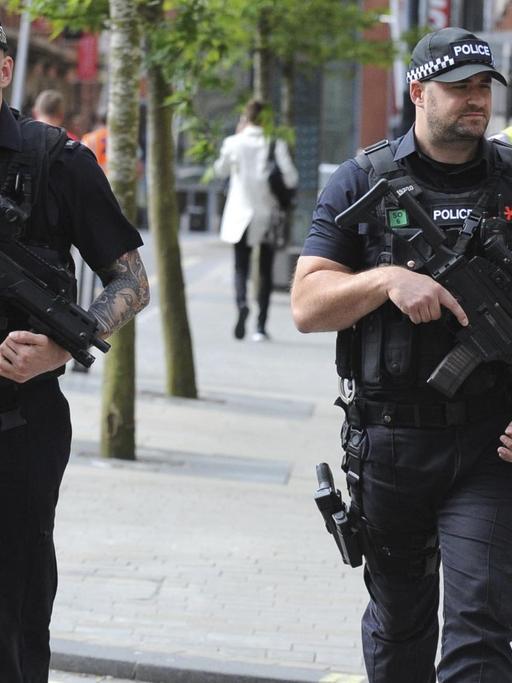 Bewaffnete Polizisten gehen in Manchester nach dem Terroranschlag durch die Stadt.