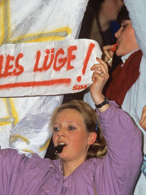 "Alles Lüge" steht auf Plakaten, die Demonstranten während einer Wahlveranstaltung von Bundeskanzler Kohl am 21.01.1987 in der Festhalle in Frankfurt am Main hochhalten. Am 25.01.1987 wurde bei den Wahlen zum Deutschen Bundestag die Regierungskoalition von CDU/CSU und FDP unter Bundeskanzler Kohl vom Wähler bestätigt.