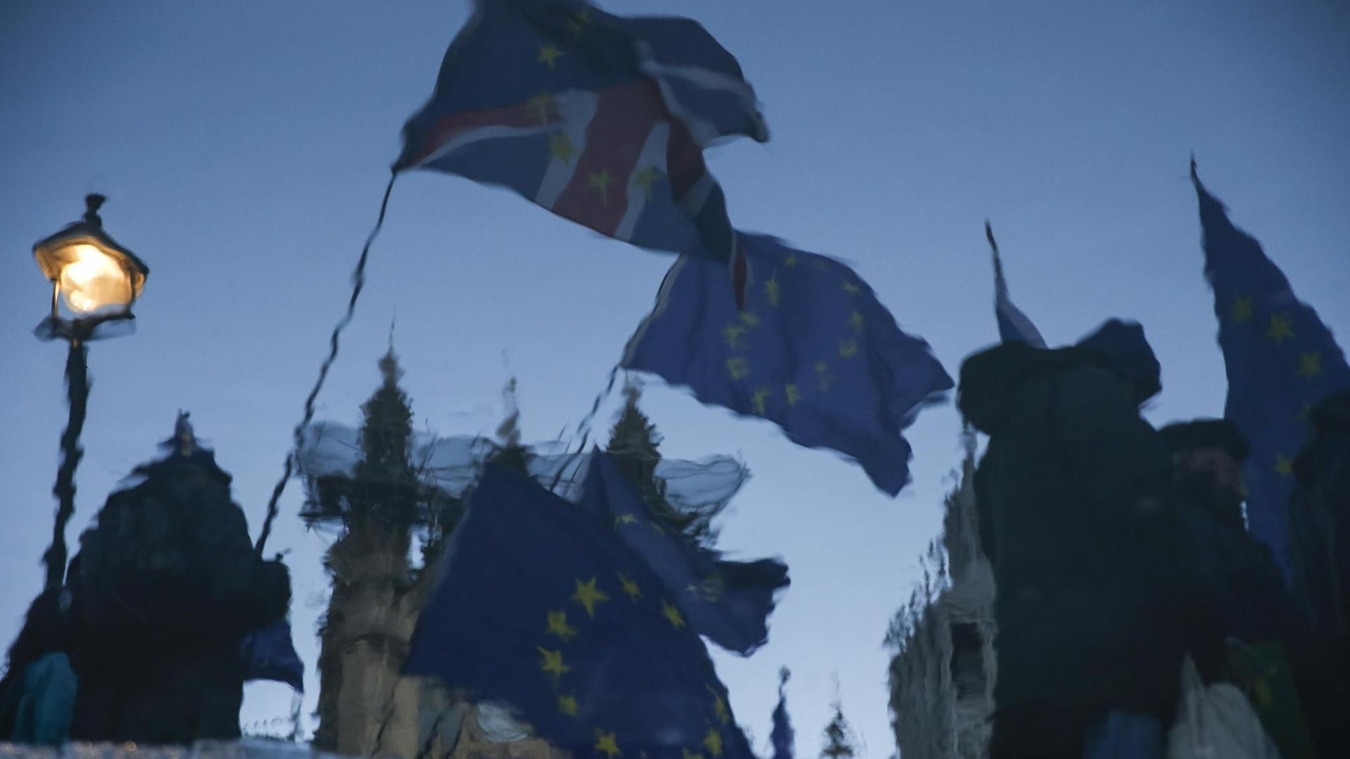 Die britische und die EU-Flagge spiegeln sich in einer Pfütze