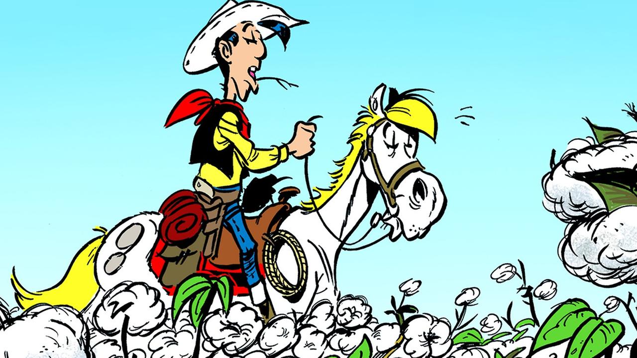 Eine Illustration aus dem Band "Fackeln im Baumwollfeld": Lucky Luke reitet über eine Baumwollplantage
