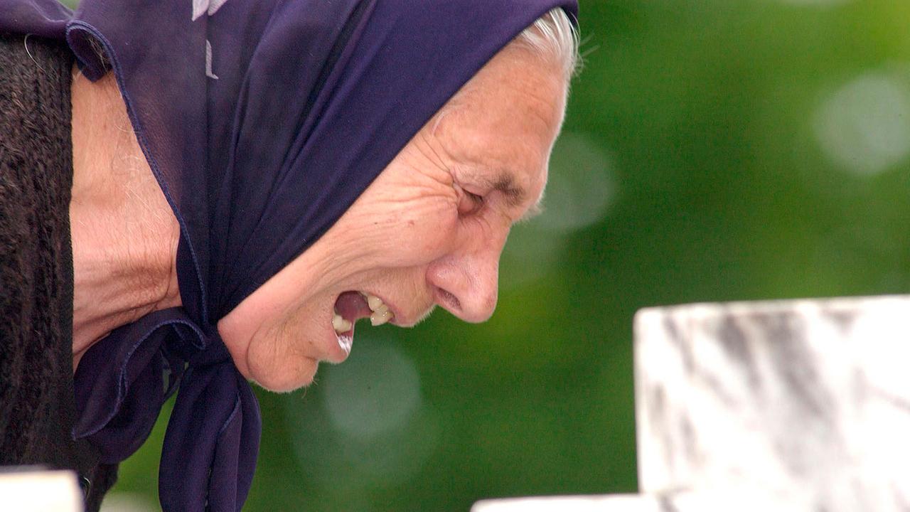 Bosnian Serb woman mourning at the grave of a relative in the small town of Bratunac near Srebrenica, Bosnia and Herzegovina.
