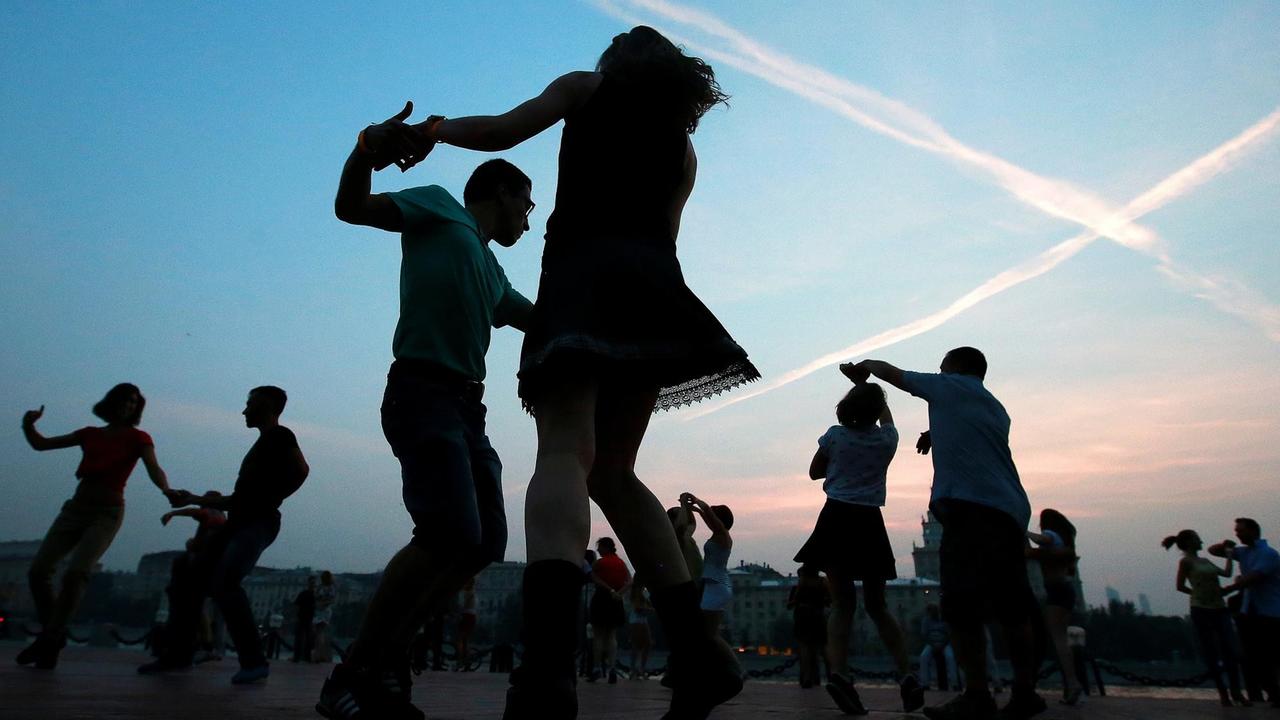 Silhouetten von tanzenden Menschen im Moskauer Gorki-Park.  