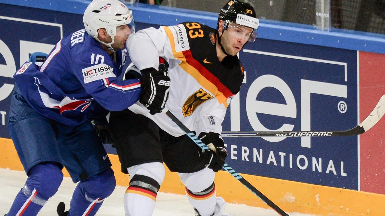 Eishockey WM in Prag: Frankreich - Deutschland am 02.05.2015 in der O2 Arena in Prag (Tschechien). Deutschlands Brent Raedeke und Frankreichs Laurent Meunier kämpfen an der Bande um den Puck. Eishockey WM in Prag: Frankreich - Deutschland am 02.05.2015 in der O2 Arena in Prag (Tschechien). Deutschlands Brent Raedeke und Frankreichs Laurent Meunier kämpfen an der Bande um den Puck.