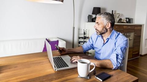 Ein Mann arbeitet zuhause am Computer