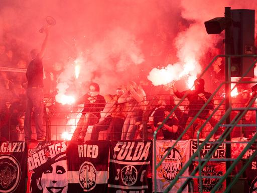 Im Fußball-DFB-Pokale-Spiel zwischen Viktoria 1889 Berlin und Eintracht Frankfurt am 16.08.2014 in Berlin zünden Frankfurt-Fans Bengalos und Feuerwerkskörper vor Anpfiff der zweiten Halbzeit.