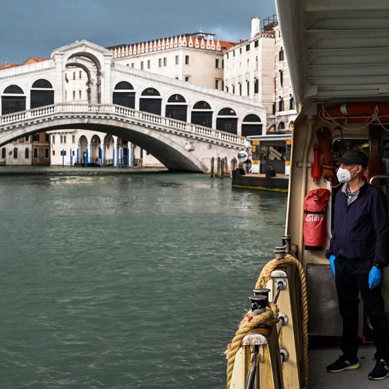 A view taken on May 12, 2020 in Venice shows a deserted Grand Canal near the Rialto bridge, during the country's lockdown aimed at curbing the spread of the COVID-19 infection, caused by the novel coronavirus. With the tourism sector reeling, the European Commission was on May 13, 2020 to present a rescue plan for the sector. Vincenzo PINTO / AFP