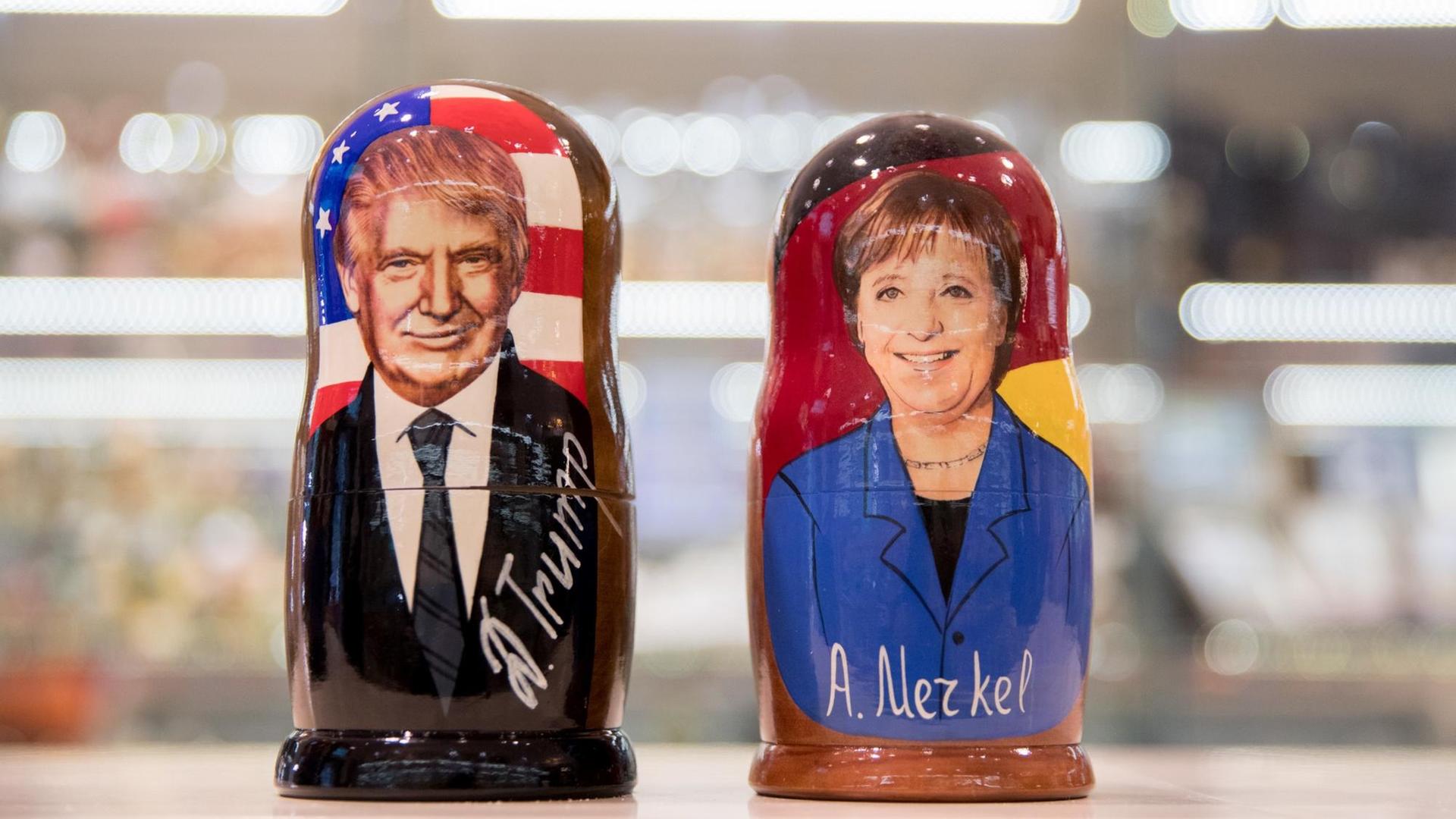 Die Konterfeis von US-Präsident Donald Trump und Bundeskanzlerin Angela Merkel (CDU) sind auf Matroschka-Puppen in einem russischen Souvenirladen am Roten Platz in Moskau zu sehen.