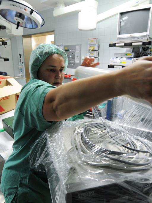 Eine Schwester packt im OP-Bereich der Klinik für Hals-, Nasen- und Ohrheilkunde in Marburg ein Gerät ein.