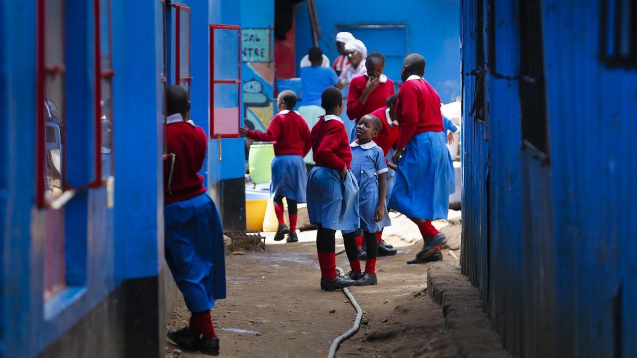 School girls play in front of their classroom in Kibera, the largest urban slum in Africa, in Nairobi, Kenya