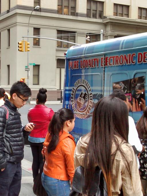Schüler geben vor einer Schule in New York City ihre Telefone ab.
