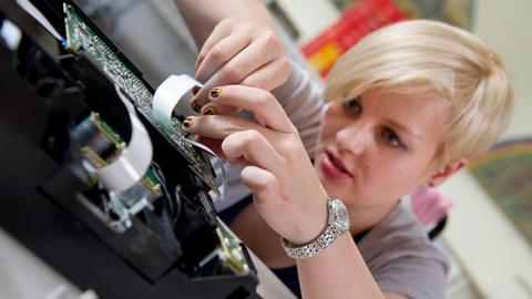 Eine junge Frau repariert am 24.06.2013 im Repair Café in Berlin-Spandau ihren CD-Player. | Verwendung weltweit