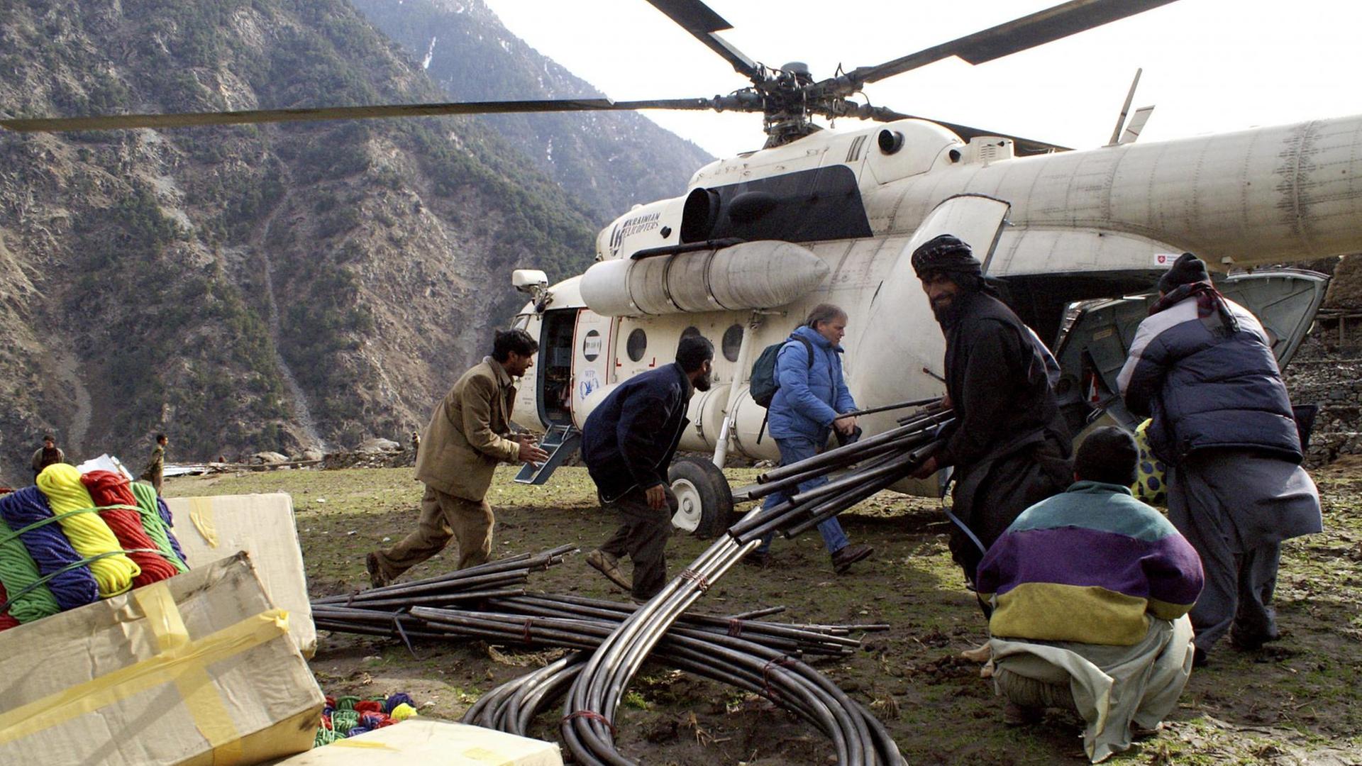 Verteilung von Hilfsgütern (Notunterkünfte) per Helikopter im Palas Tal in Pakistan durch eine Hilfsorganisation nach dem Erdbeben.