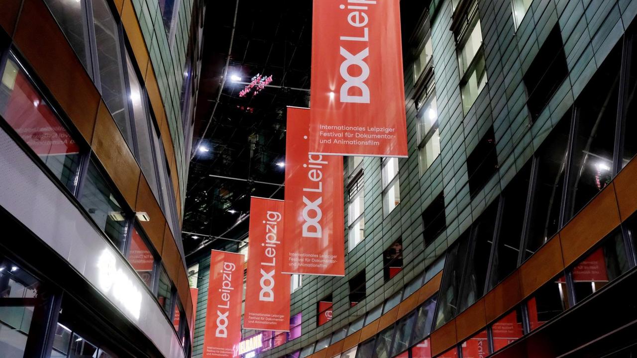 Banner mit dem Schriftzug des DOK Filmfestivals Leipzig hängen in einem Kino.