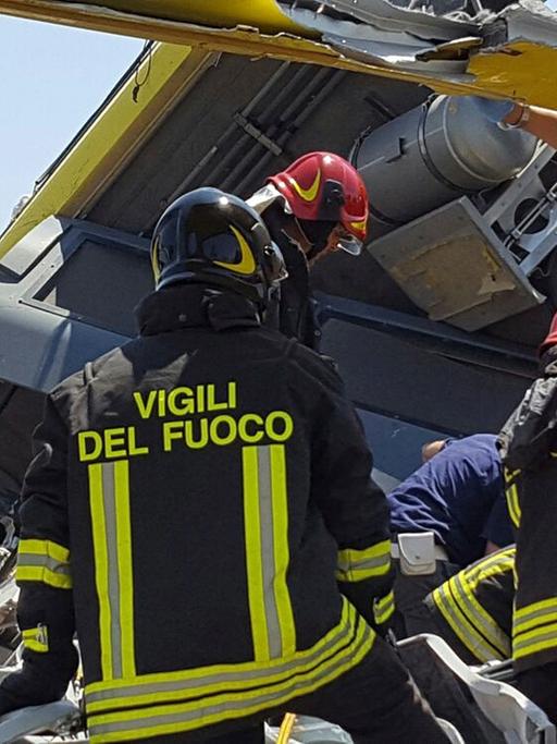 Italienische Rettungskräfte inspizieren das Wrack der beiden verunglückten Pendlerzüge.
